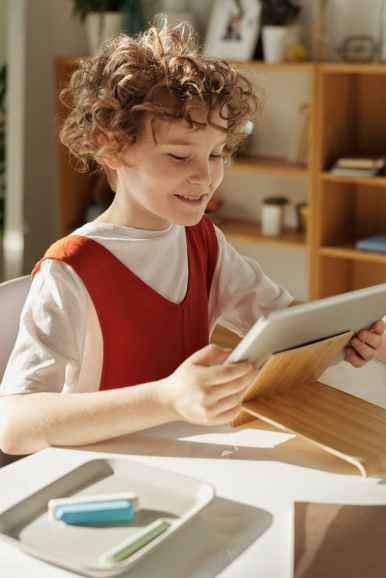 photo of child using tablet computer