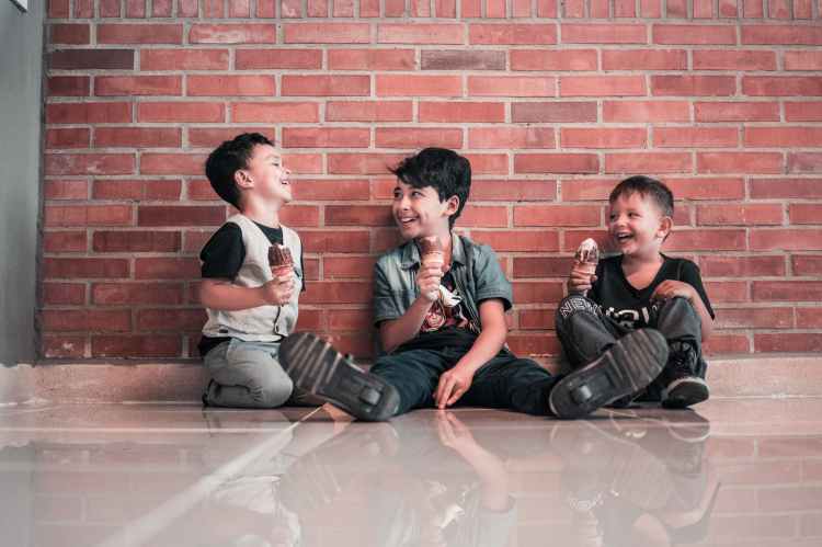 photo of boys sitting on floor